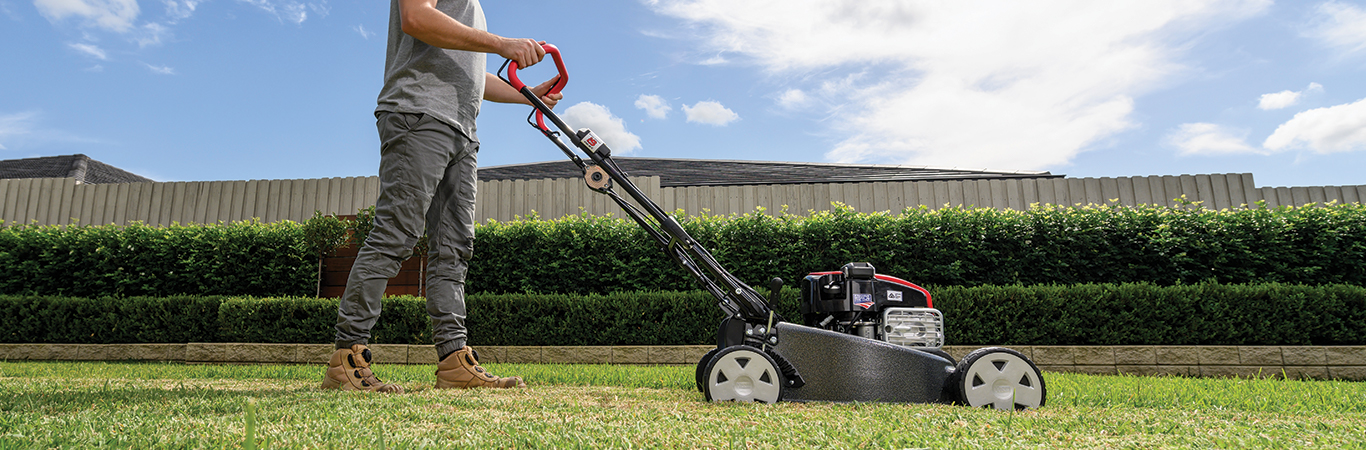 Man cutting grass with lawn mower