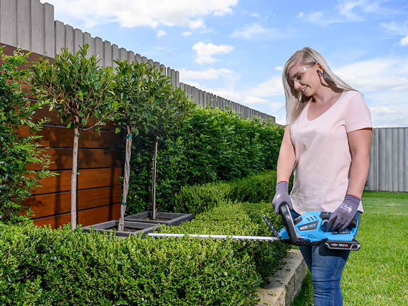 Mum trimming the lawn edge